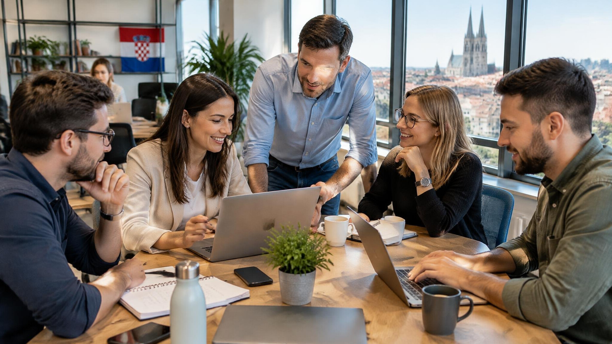Team of colleagues collaborating around a table in a bright modern office