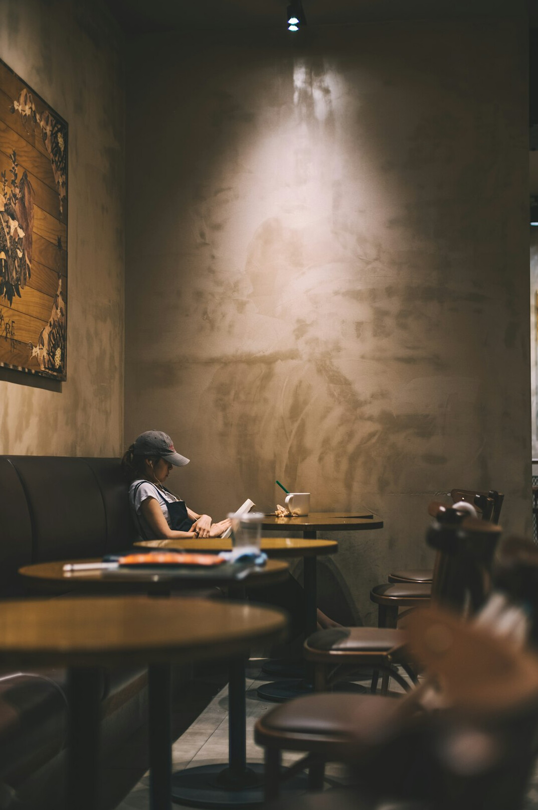 person reading book in cafe